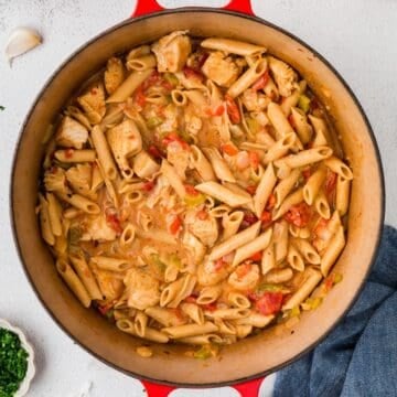 Close up of a creamy chicken pasta with Cajun flavors in a stock pot.