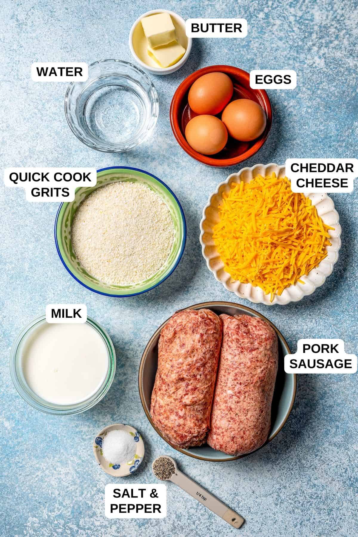 Ingredients laid out in separate containers for making a sausage and grits recipe, including eggs, milk, water and cheddar cheese.