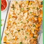 A baked chicken taco casserole with cheese and tortilla chips on top in a glass baking dish with sprinkled cilantro on top with a green border around the photo and a text label at the top.