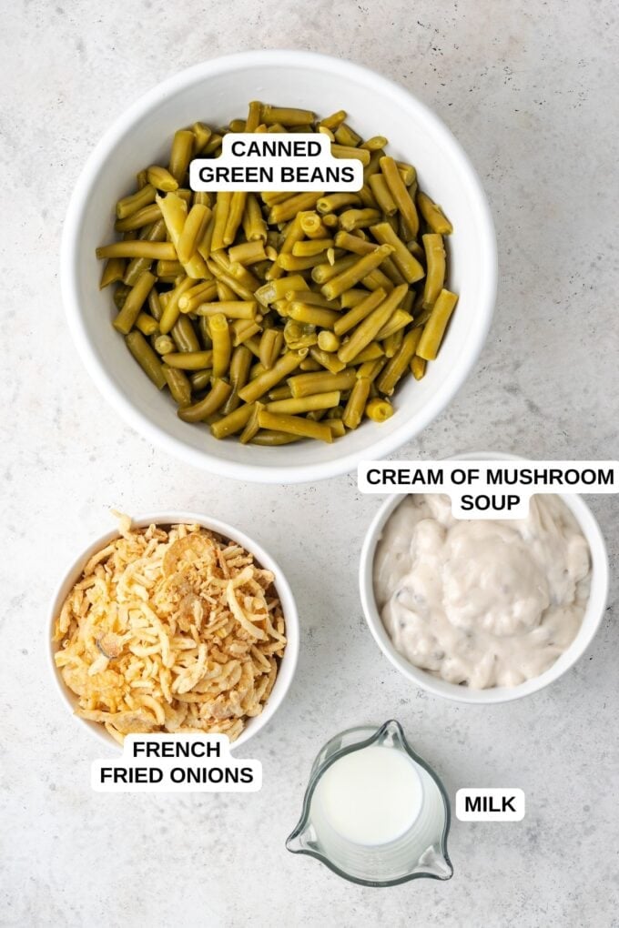 Ingredients laid out on a counter for making a green bean casserole with French fried onions and cream of mushroom soup.