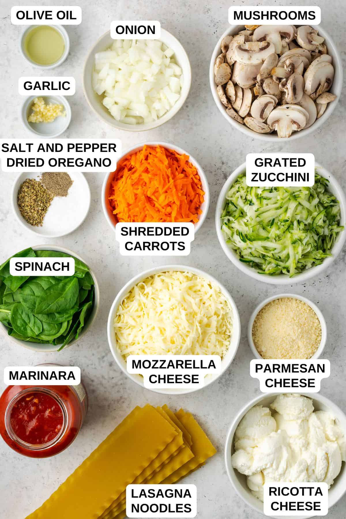 Ingredients laid out in separate bowls for making a vegetarian lasagna.