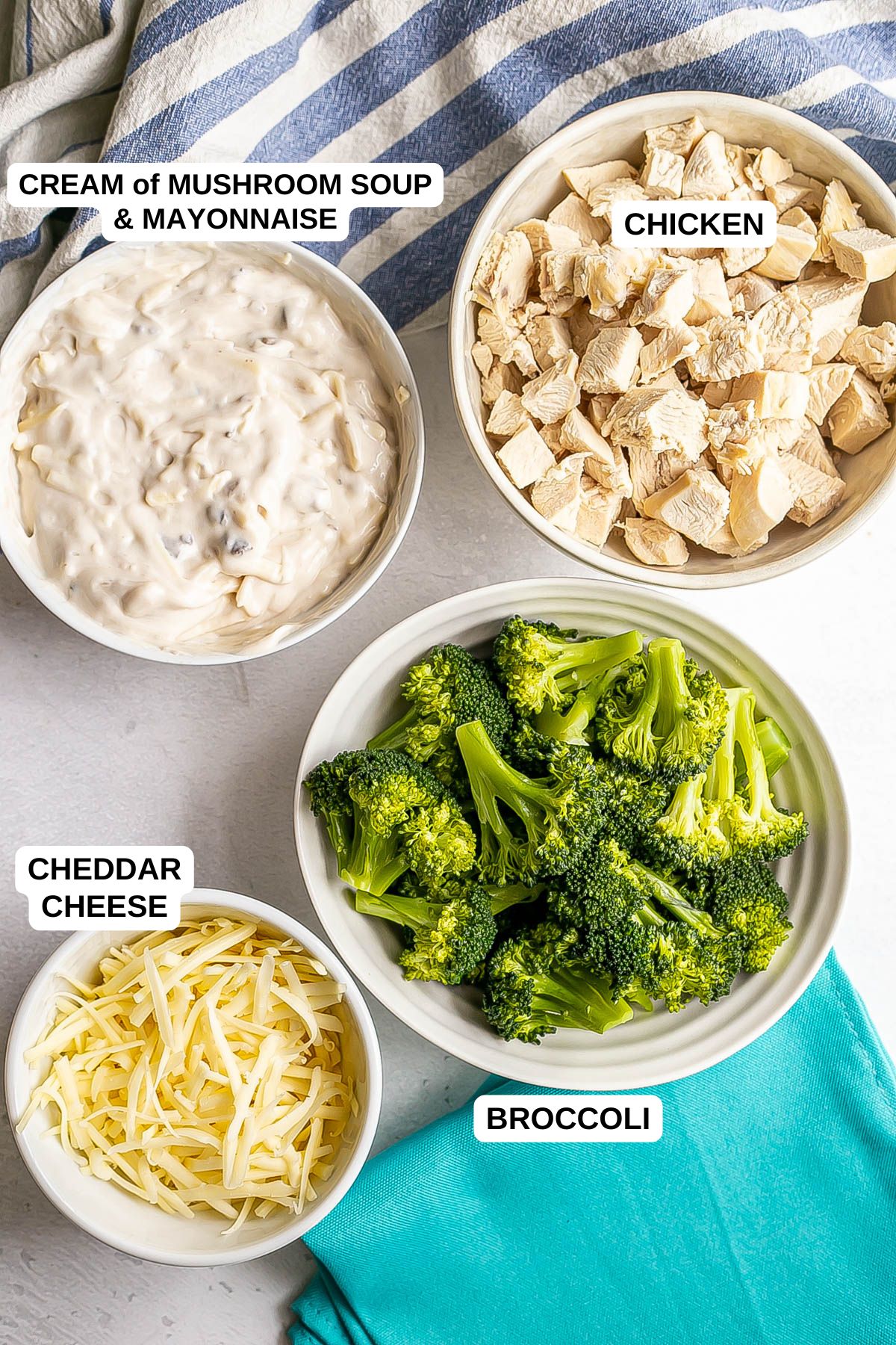 Ingredients laid out in separate bowls for making a chicken casserole with broccoli.