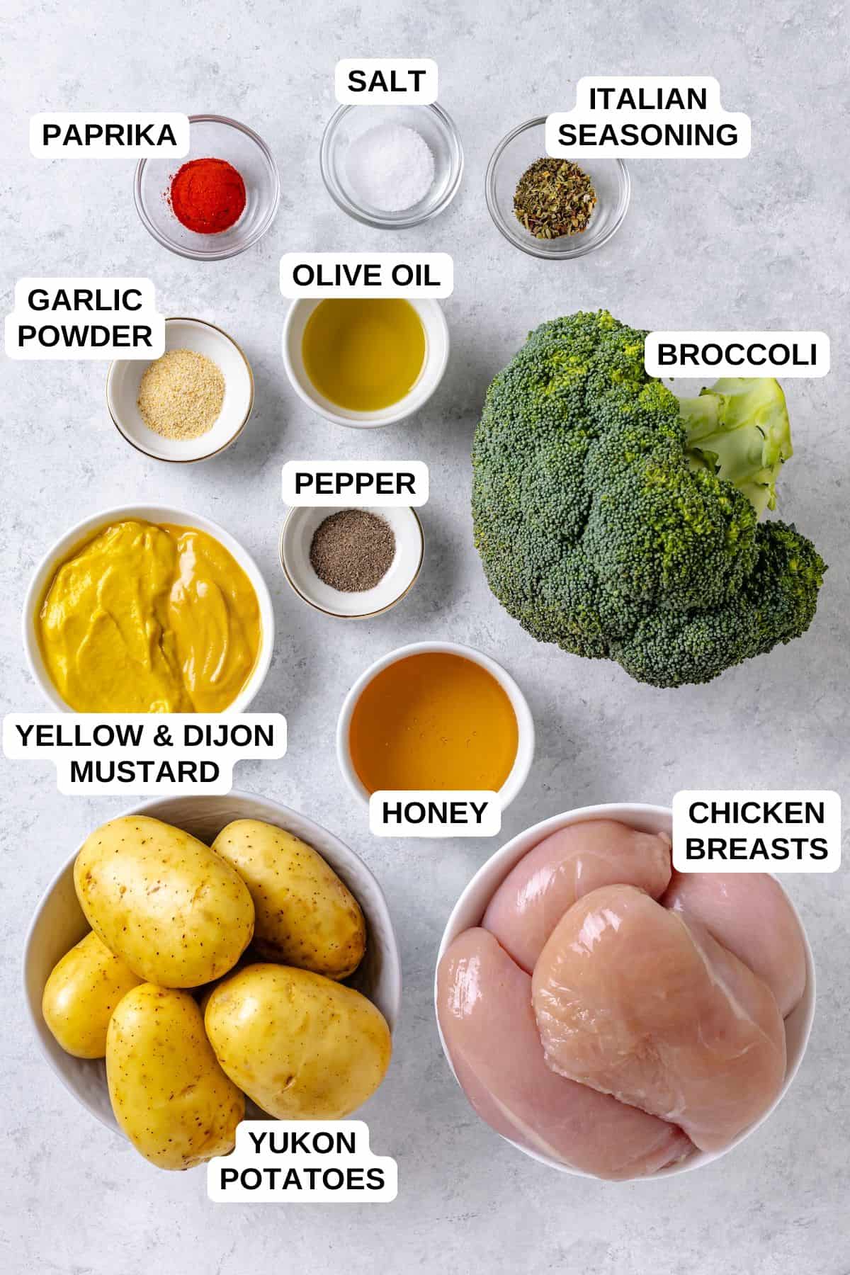 Ingredients laid out in separate bowls for making a chicken recipe with potatoes and broccoli.