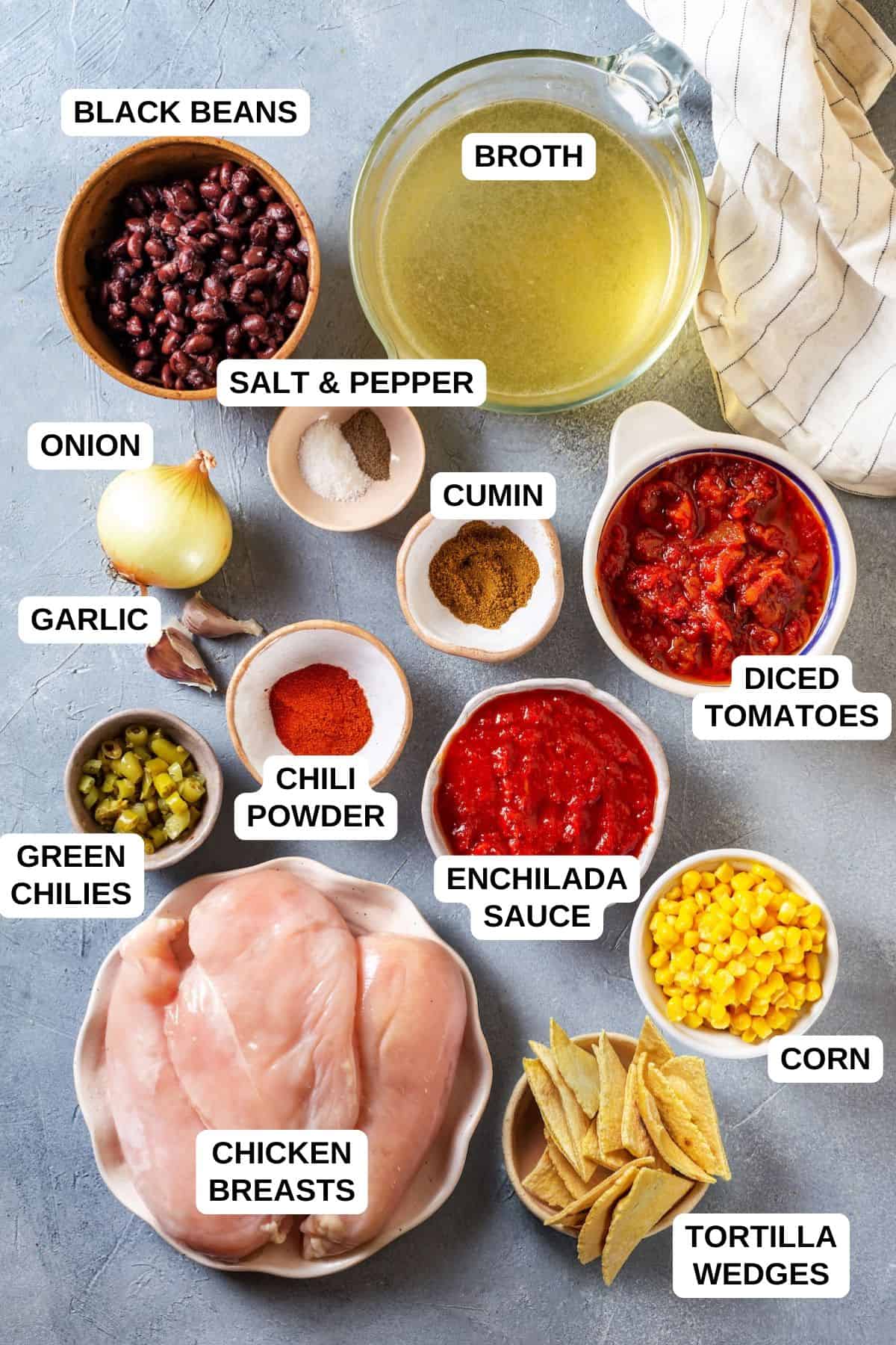 Ingredients laid out in separate bowls for making a chicken enchilada soup recipe.