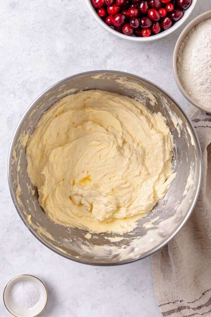 A creamy cake batter in a silver mixing bowl.