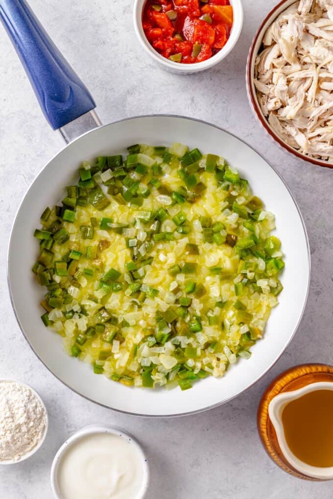 Sautéed onion and green peppers in a skillet.