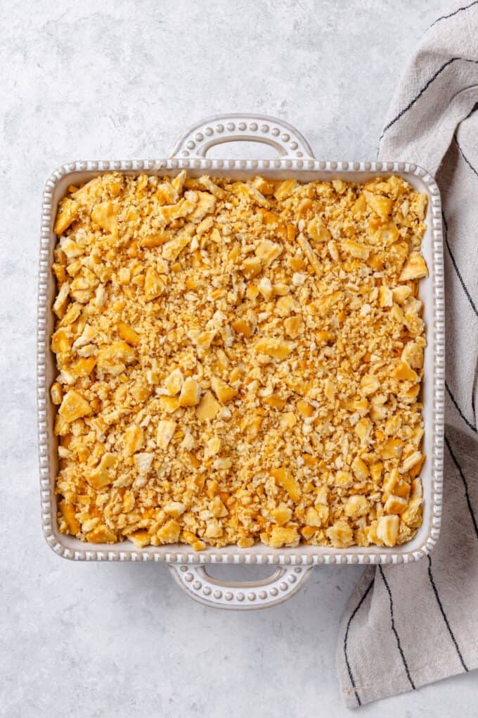 A cracker crumb topping in a casserole dish before being cooked.