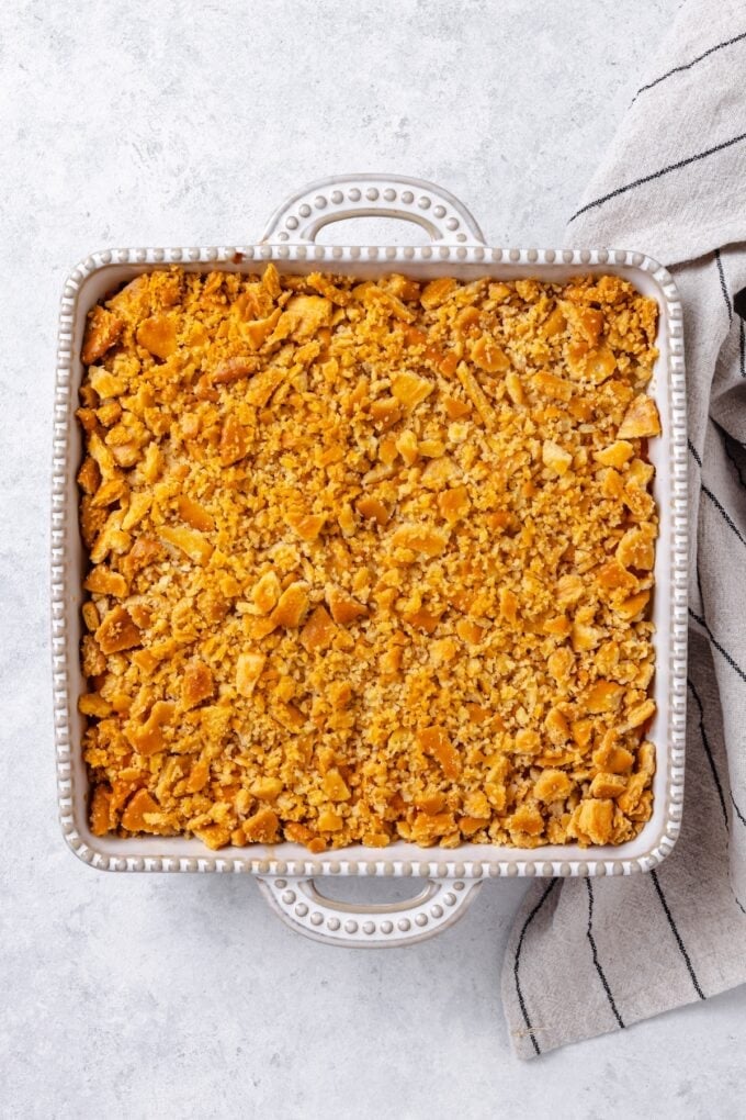 A baked pineapple casserole with cheese and a cracker topping.