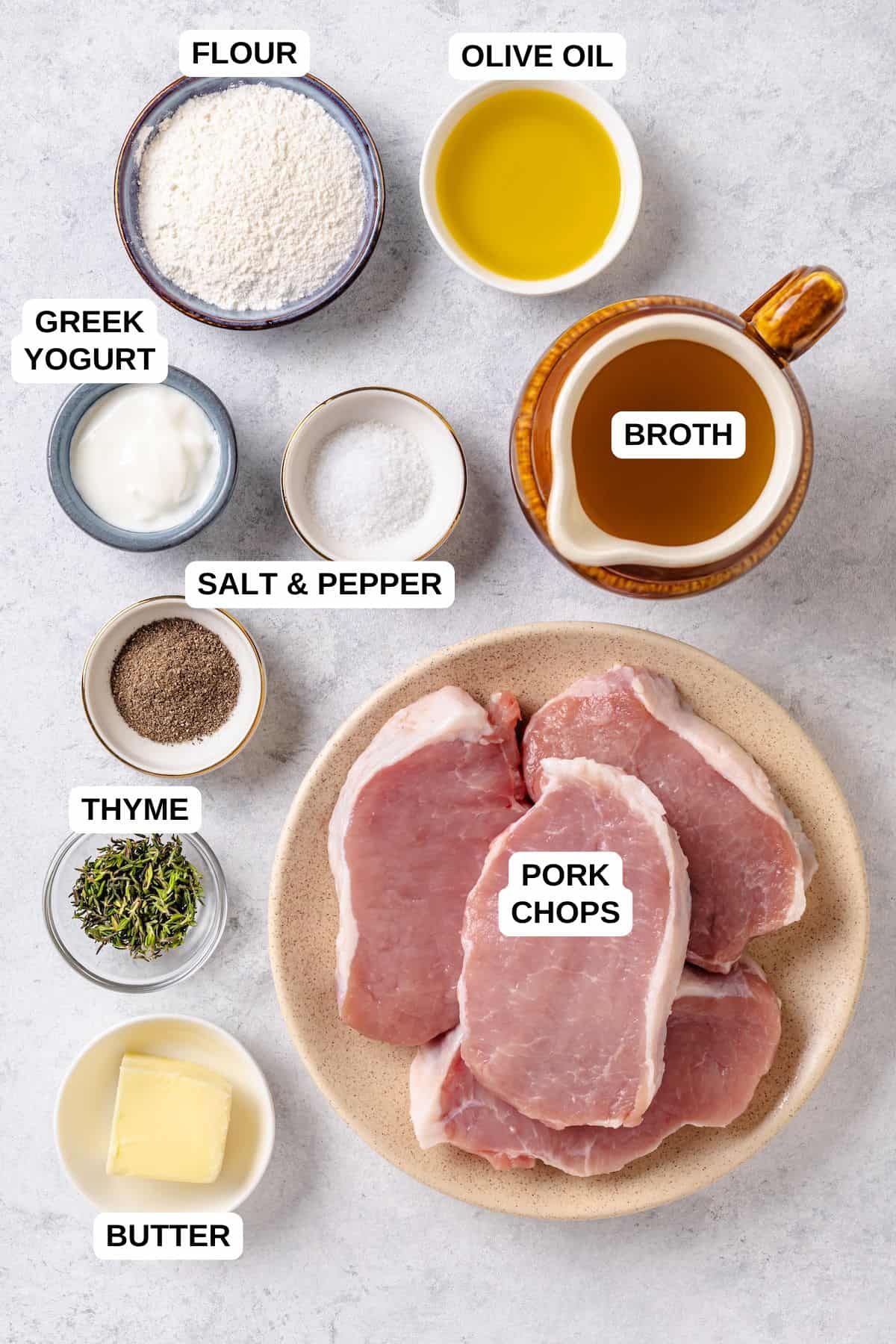 Ingredients laid out in separate bowls and plates for making a pork chops and gravy recipe.