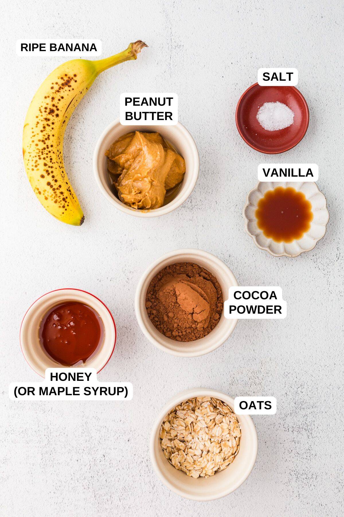 Ingredients laid out in separate bowls for making a healthier chocolate pudding dessert with honey, peanut butter and banana.