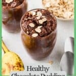 Top down look of a couple of glass jars filled with a fudgy chocolate pudding dessert with oats sprinkled on top and to the side, along with a ripe banana and two spoons with a green border and text around the photo.