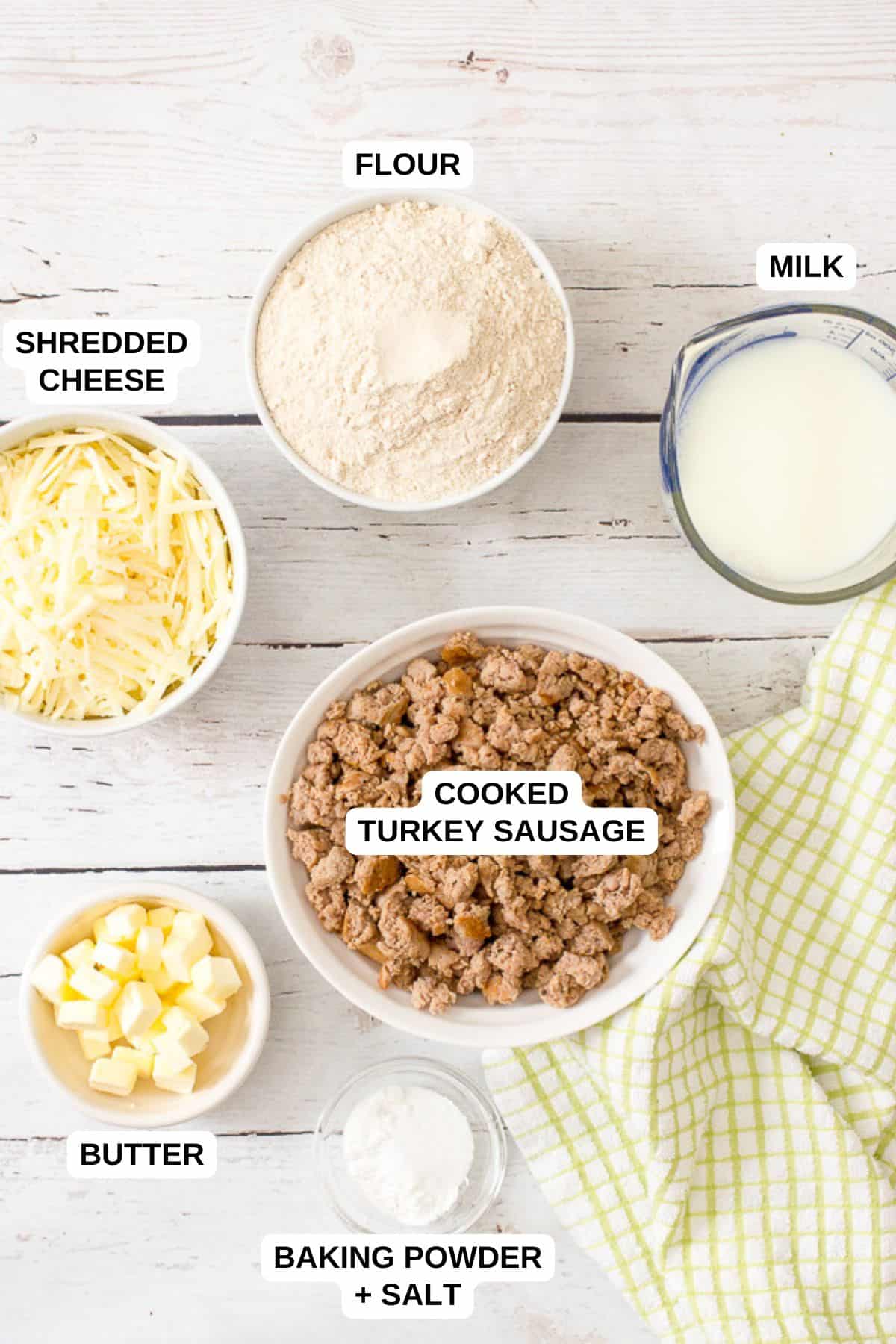 Ingredients laid out in separate bowls for making homemade sausage balls with turkey sausage and cheese.