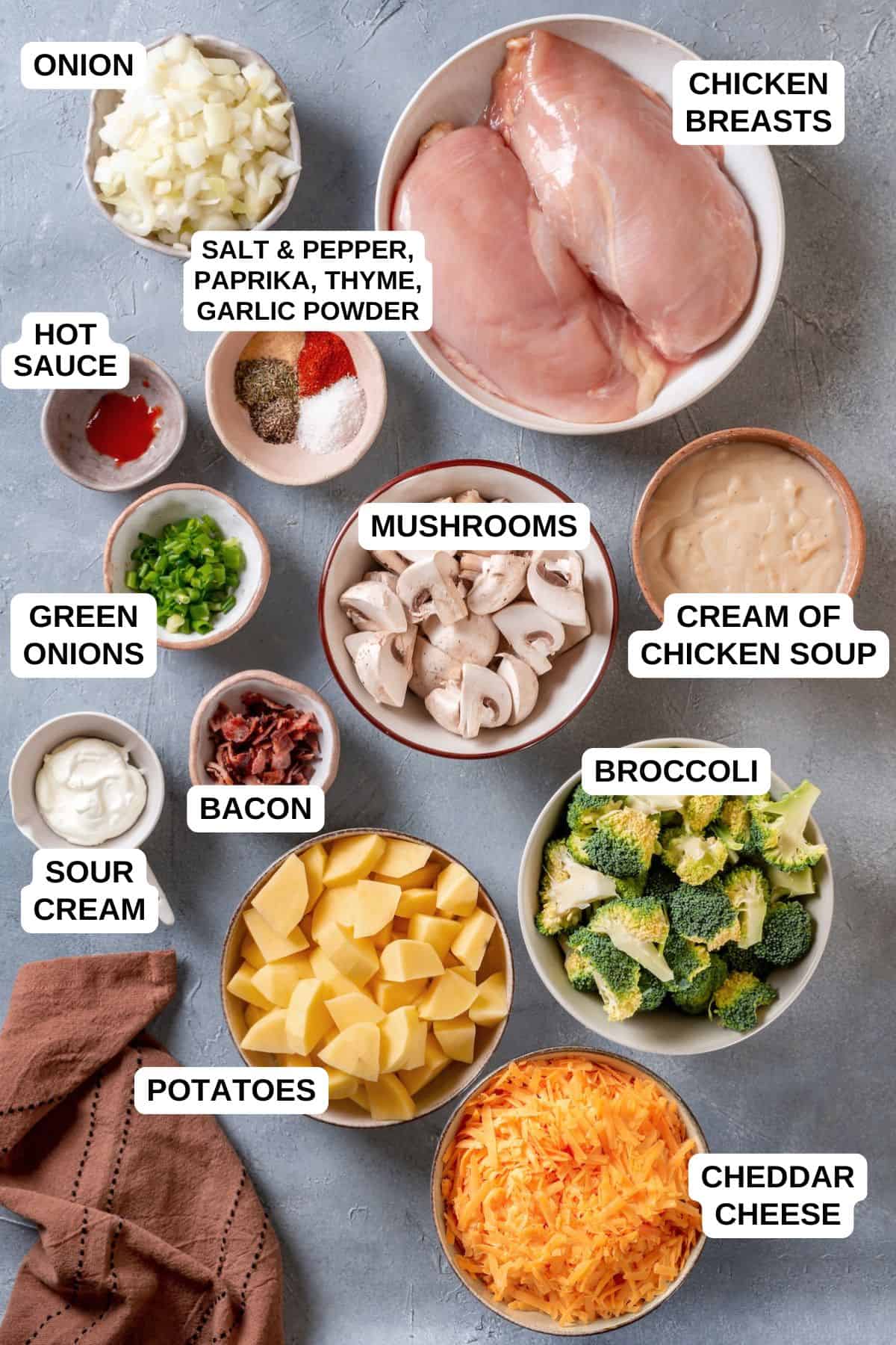 Ingredients laid out in separate bowls for making a chicken casserole with potatoes and broccoli.