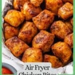 Seasoned, cooked Air Fryer chicken bites in a bowl with a green border and text around the photo.