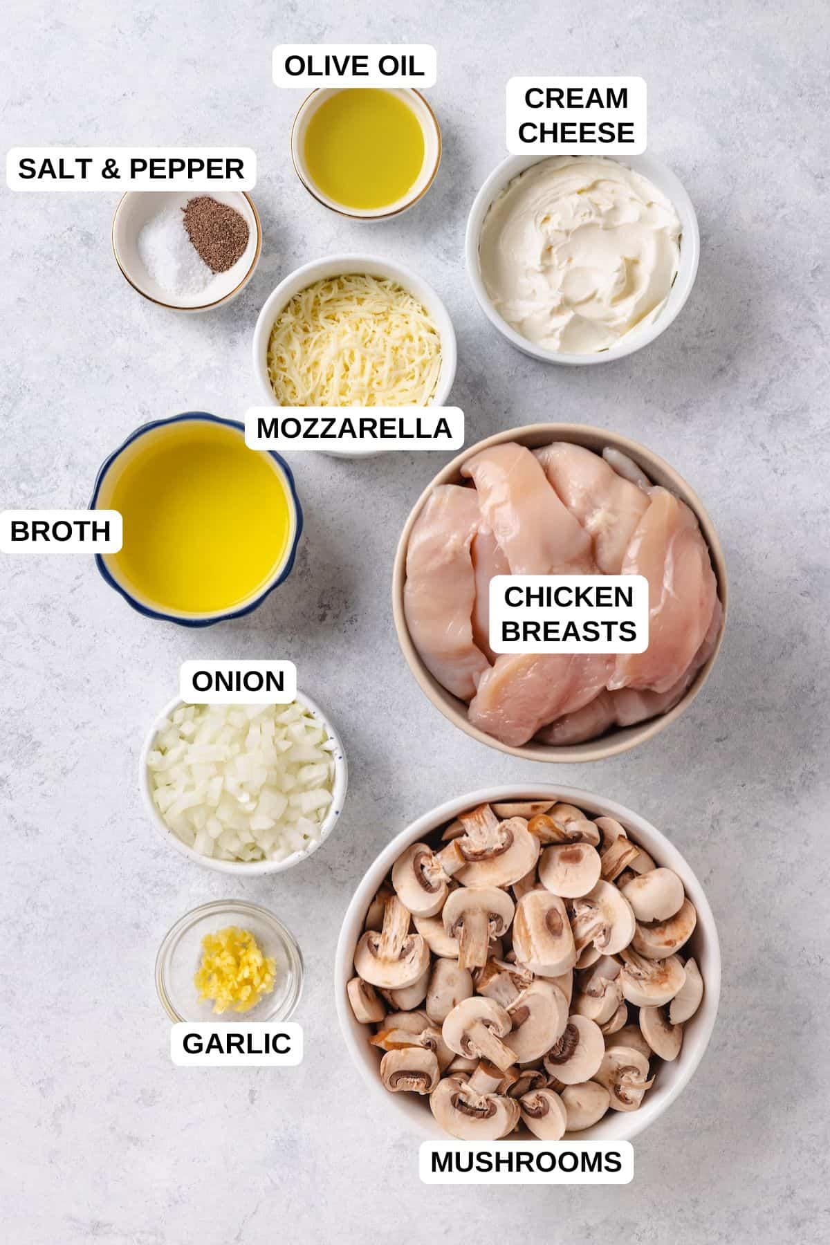 Ingredients laid out in separate bowls for making a cream cheese chicken recipe with onion and mushrooms.