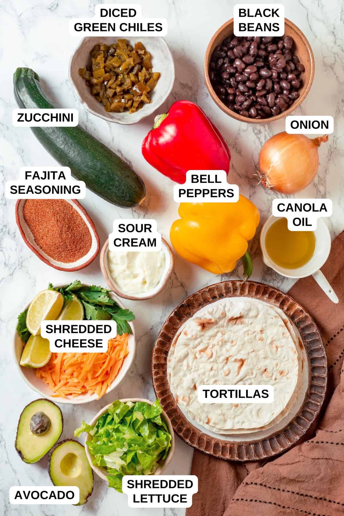 Ingredients laid out in separate bowls for making a black bean and veggie fajitas skillet.