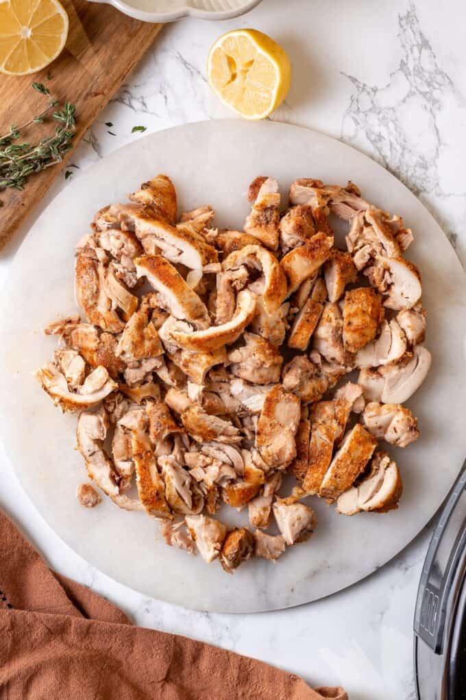 Cooked, chopped chicken thighs on a plate.