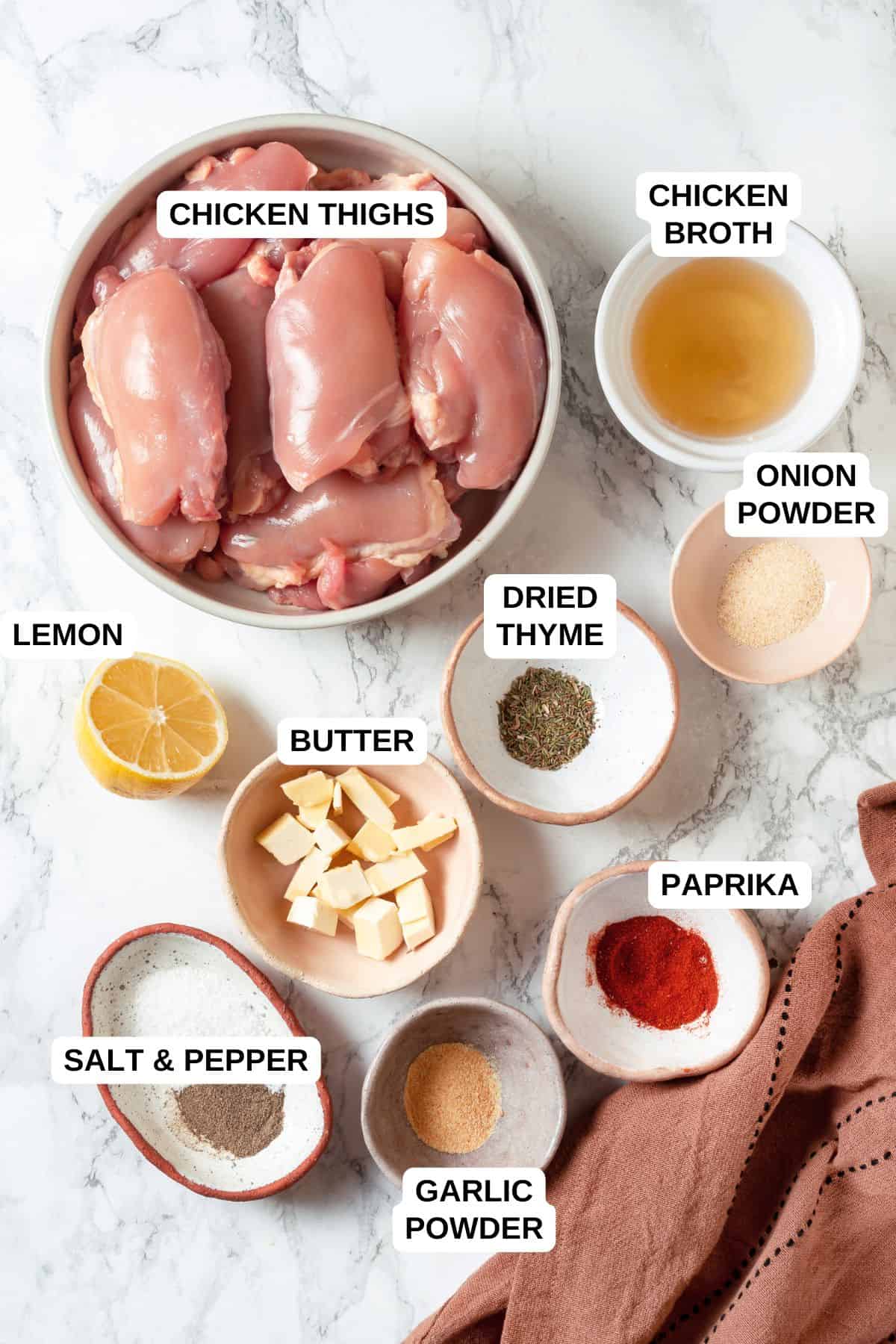 Ingredients laid out in separate containers for making a seasoned chicken thighs recipe.