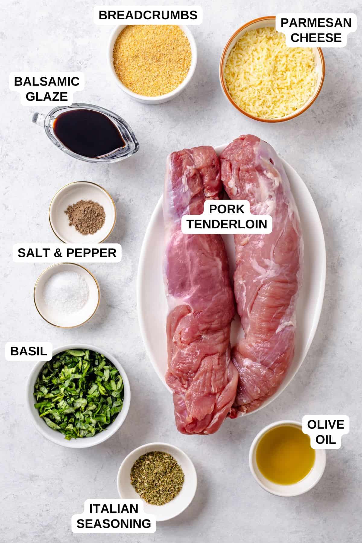 Ingredients laid out in separate bowls and containers for making a stuffed pork tenderloin recipe with breadcrumbs, Parmesan cheese and basil.