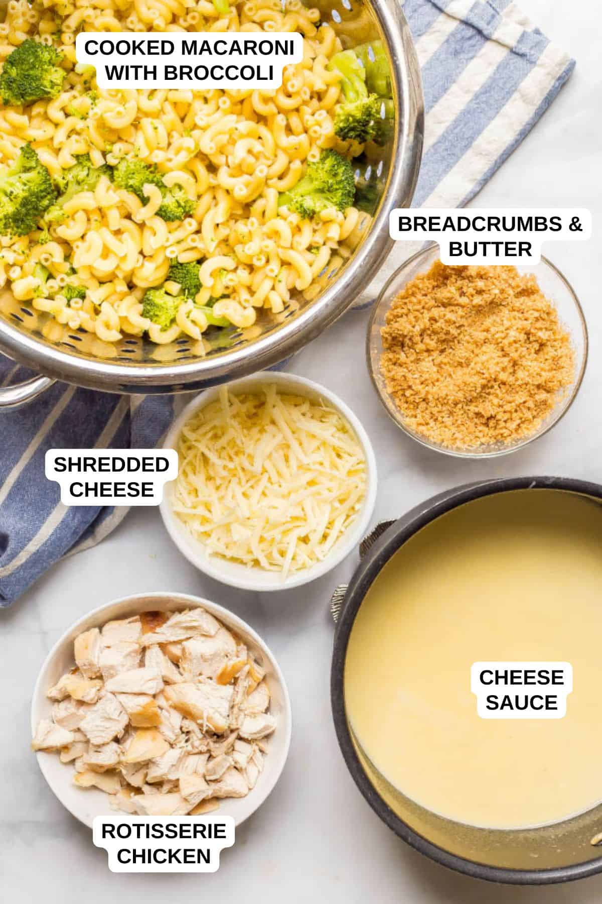 Ingredients laid out in separate bowls for making a macaroni and cheese recipe with broccoli and chicken.