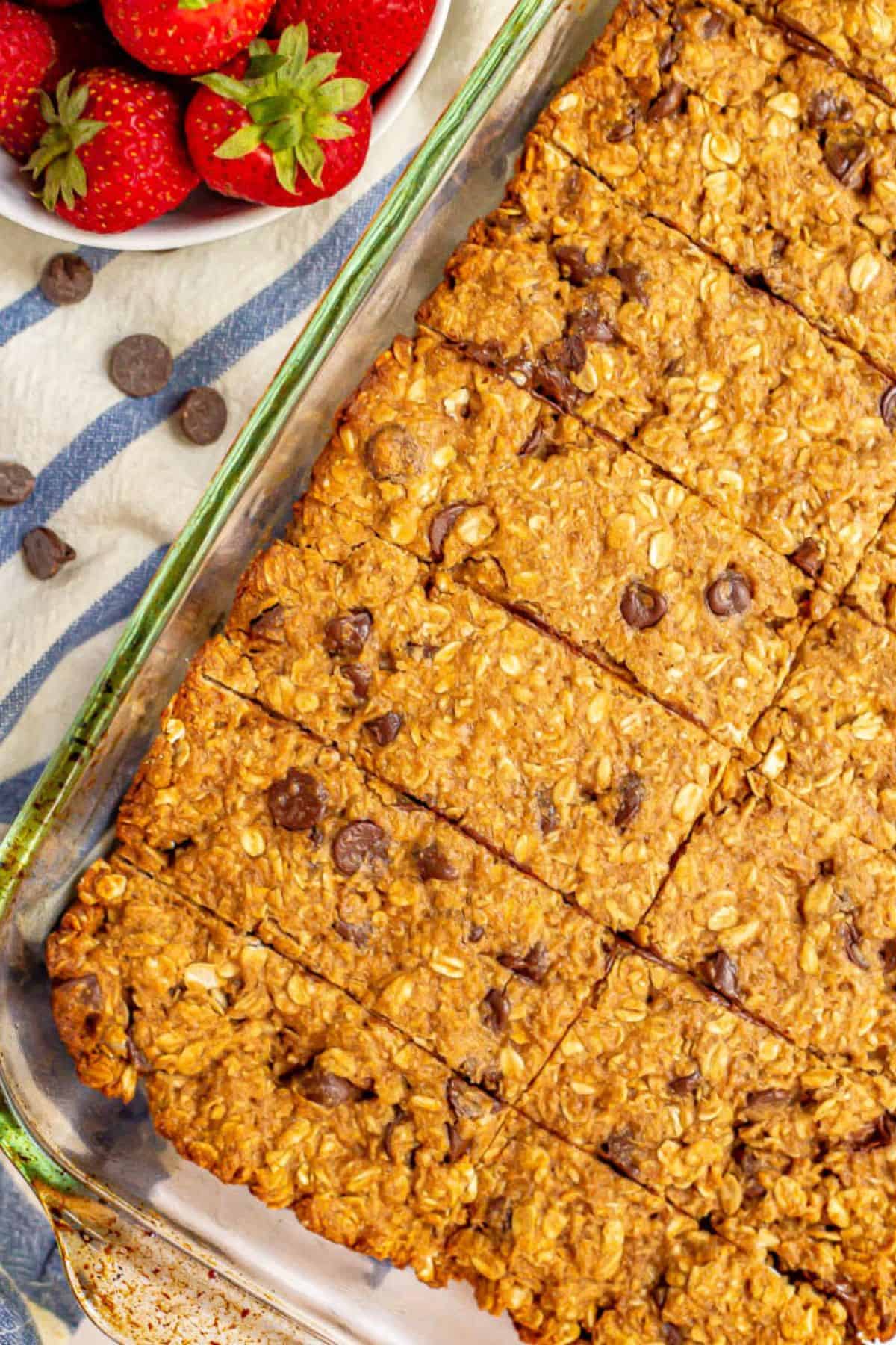 A glass 9x13 baking dish with homemade granola bars after being cooled and cut into bars.