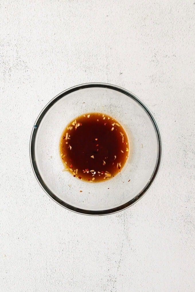 A homemade honey garlic sauce mixed in a small glass bowl.