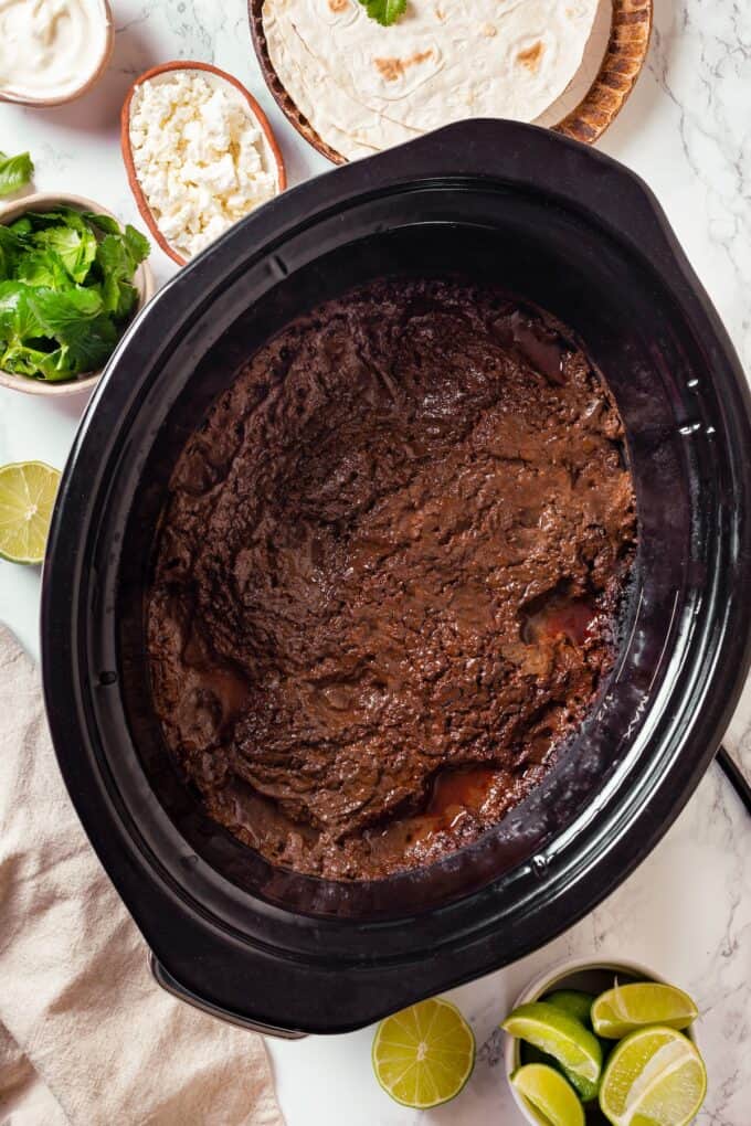 A cooked mole chicken in a slow cooker.
