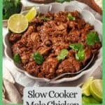 Saucy mole chicken in a low serving bowl with cilantro and lime on top and a serving spoon to the side with a border and text around the image.