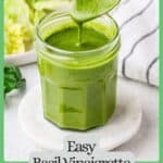 A spoon drizzling fresh homemade basil vinaigrette in a glass jar with a salad in the background with a green border and text around the photo.
