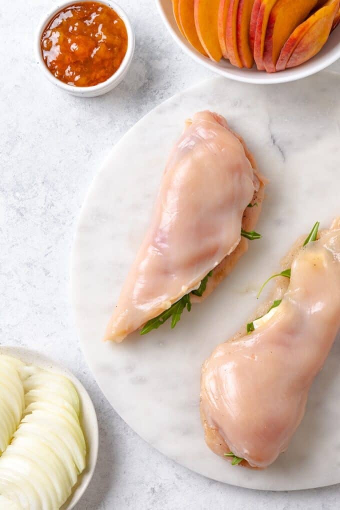 Butterflied chicken breasts stuffed with brie cheese and folded over.