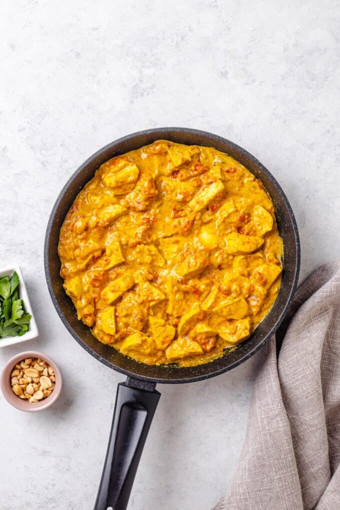 Greek yogurt stirred into a tomato curry sauce with chicken in a skillet to add some creaminess.