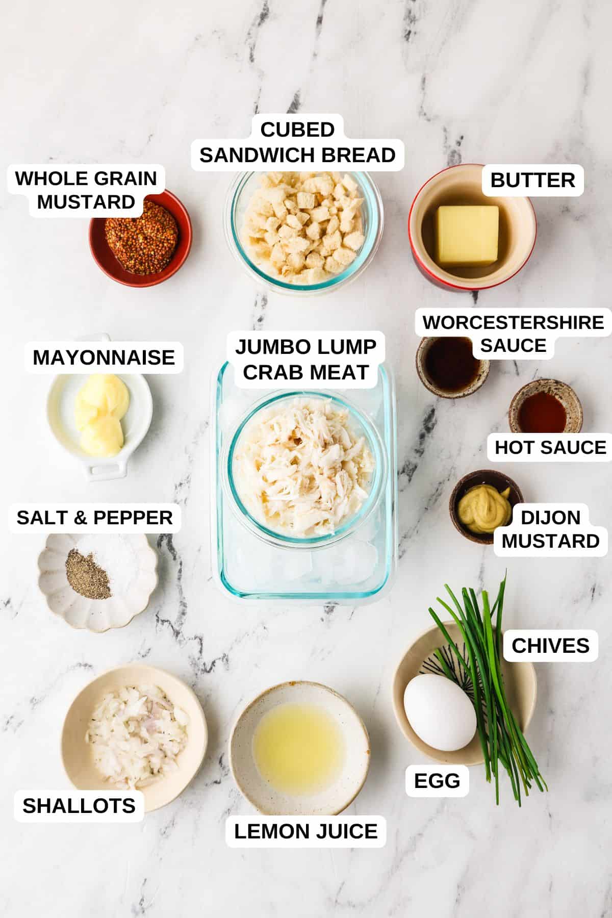 Ingredients laid out in separate containers for making homemade crab cakes with a mustard sauce.