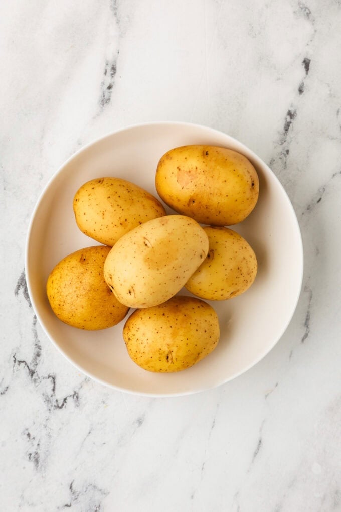 A bowl full of Yukon gold potatoes before being cooked.