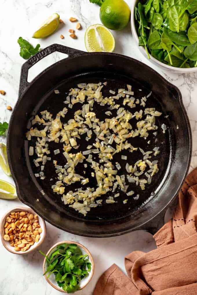Sautéed onions in a large cast iron pan.