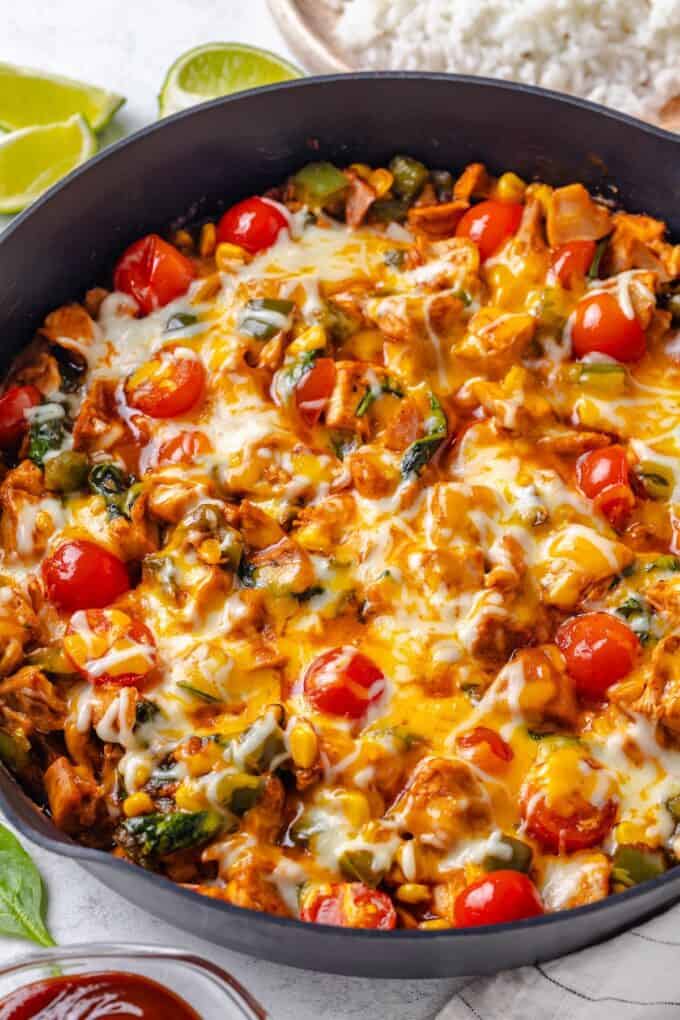 A cheesy BBQ chicken skillet in a cast iron pan.