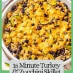 A spoon lifting out a scoop of a ground turkey skillet with zucchini and black beans and melted cheese on top with a green border and text around the photo.