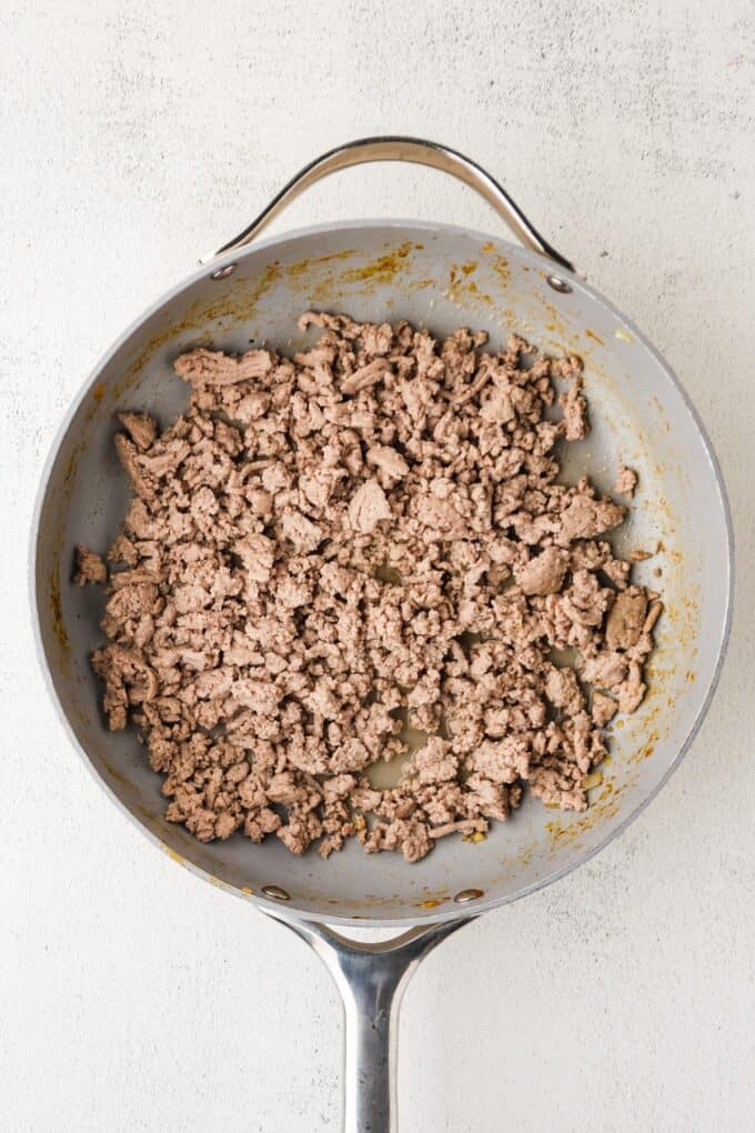 Crumbled, cooked ground turkey in a large skillet.