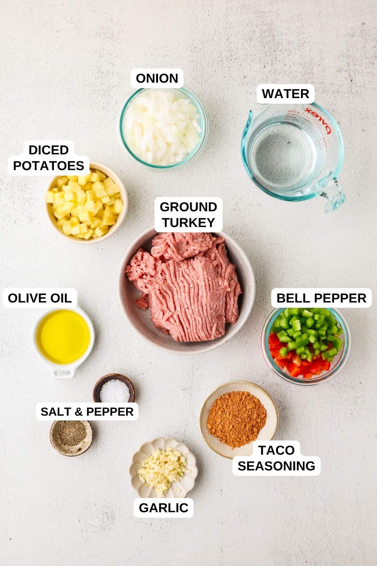 Ingredients laid out in separate containers for making a ground turkey recipe with potatoes, peppers and taco seasoning.