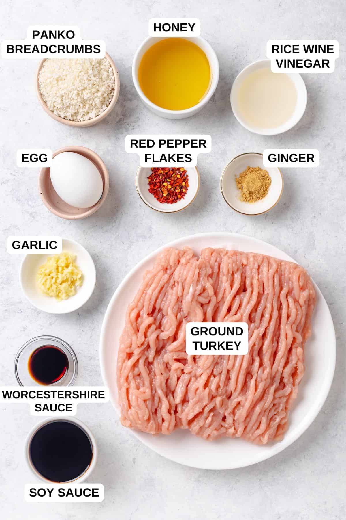 Ingredients laid out in separate bowls for making a ground turkey meatball recipe with soy sauce and garlic.