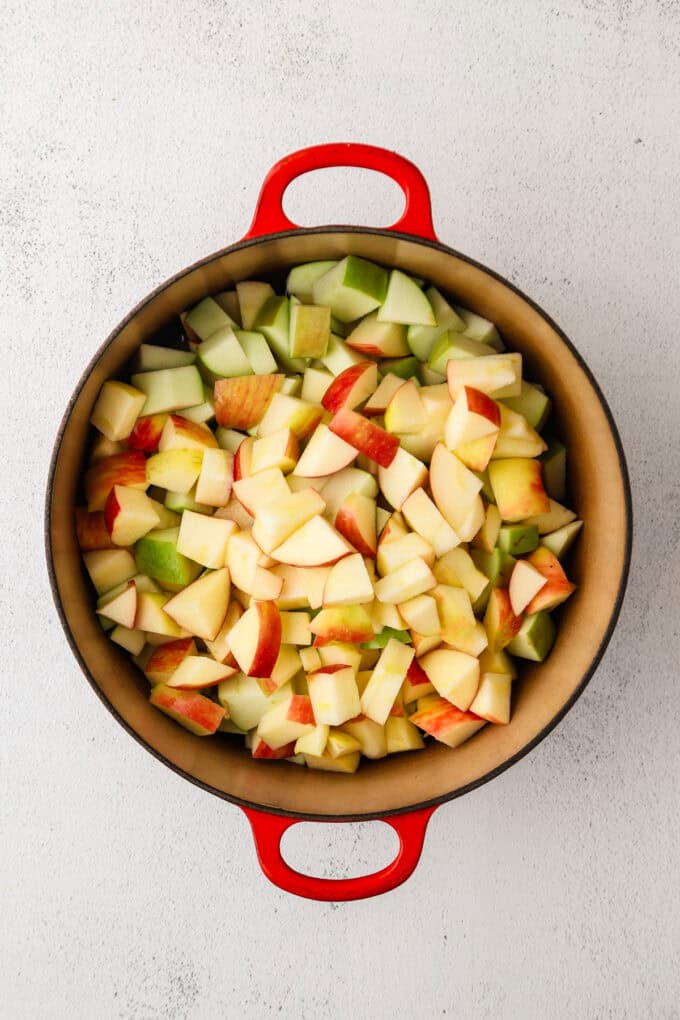 A large dutch oven filled with diced apples.